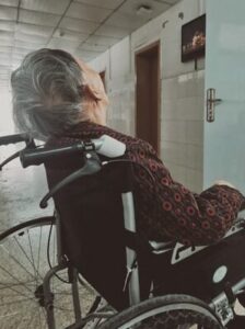 A frail elderly sitting on wheelchair with physical inactivity and sundown syndrome