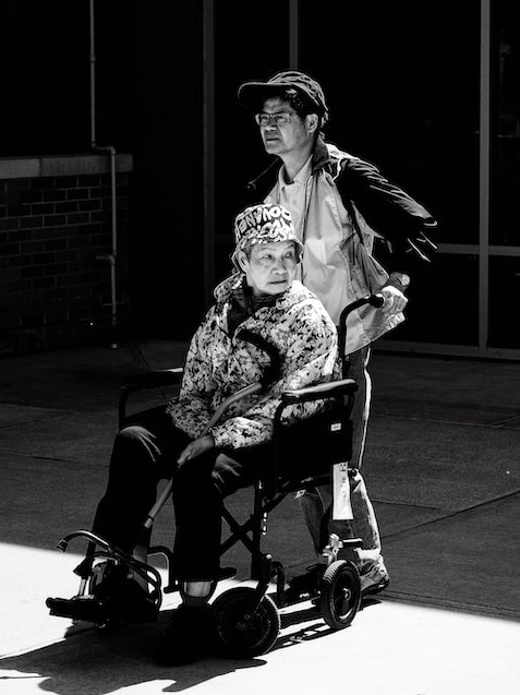 Caregiver with elderly on wheelchair