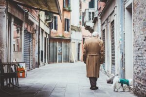 Elderly walking a dog